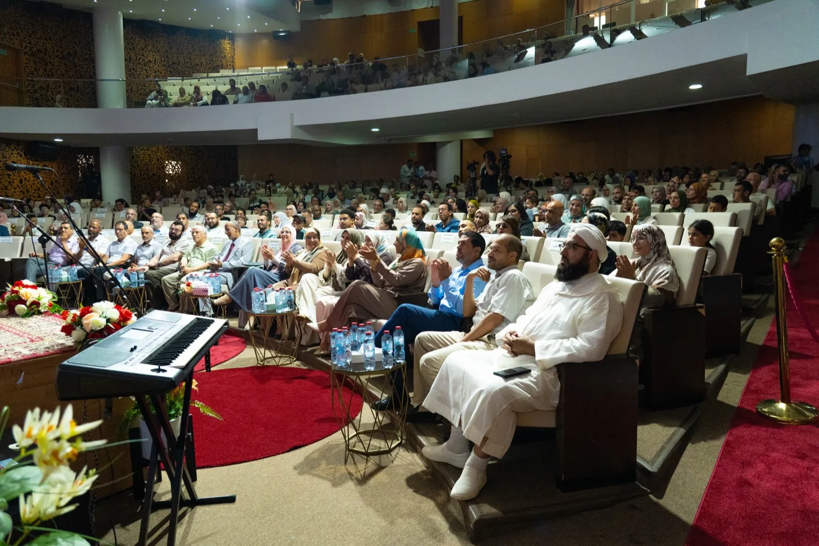 Families, teachers, and guests filling the auditorium at the Qutuf Al Mouwatana graduation ceremony in Rabat